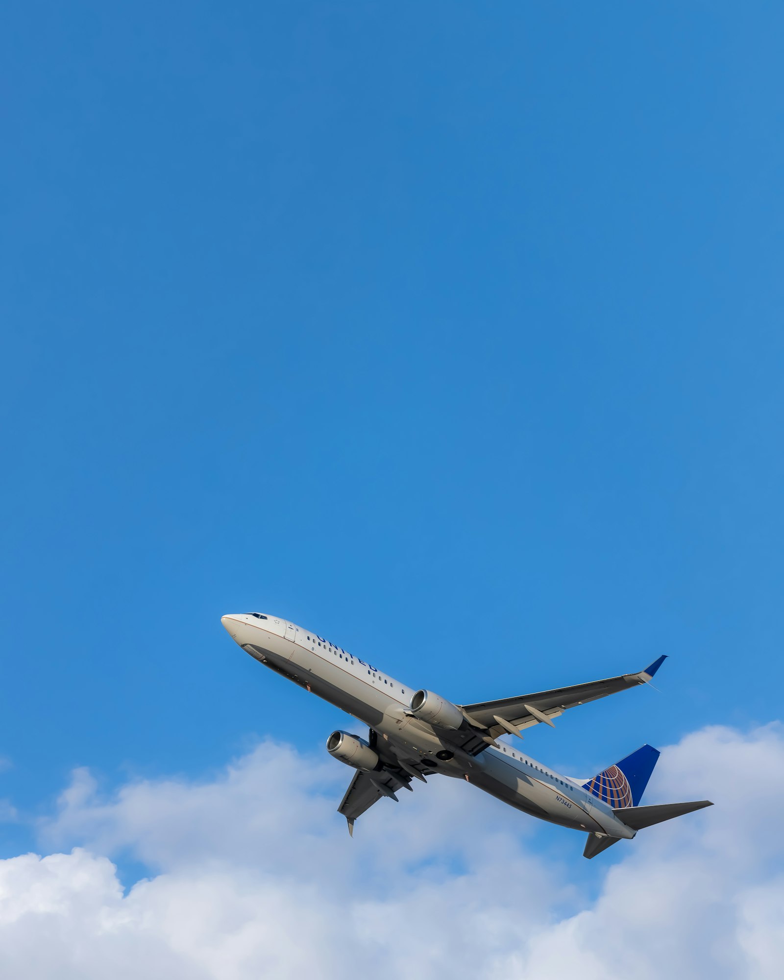 Passenger airplane climbing into a blue sky