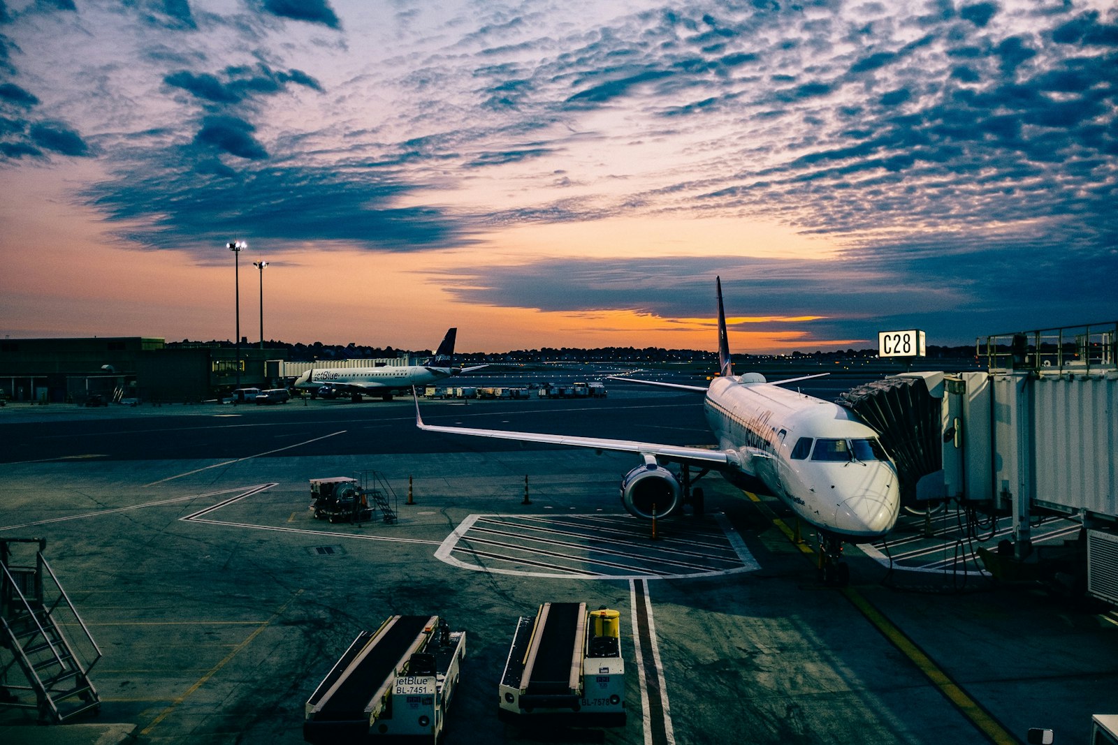 Passenger airplane parked at an airport gate at dusk